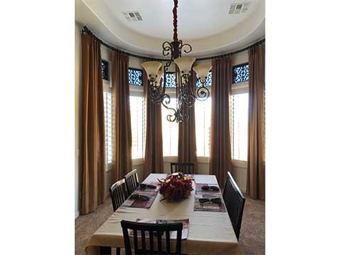 Dining room with fancy drapes and a chandelier